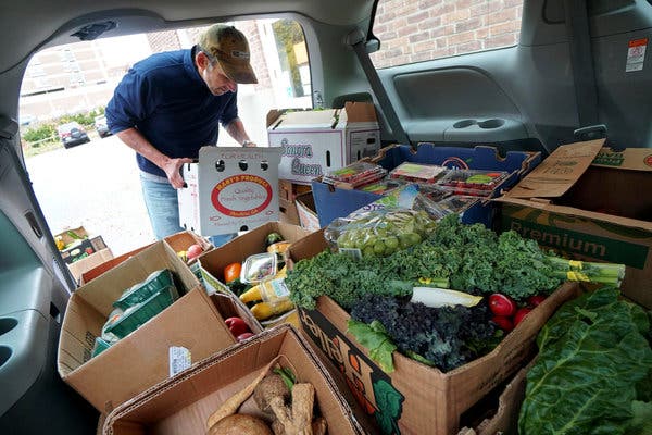 A volunteer delivering produce donated by local grocery stores to a food pantry at South Congregational Church in Pittsfield, Mass., this fall.
