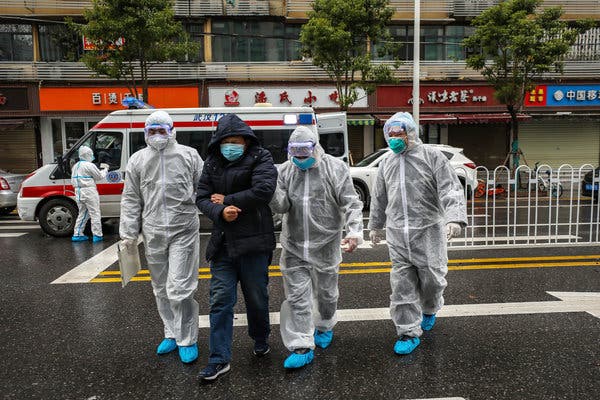 Medical workers with a patient in Wuhan, China, on Sunday.