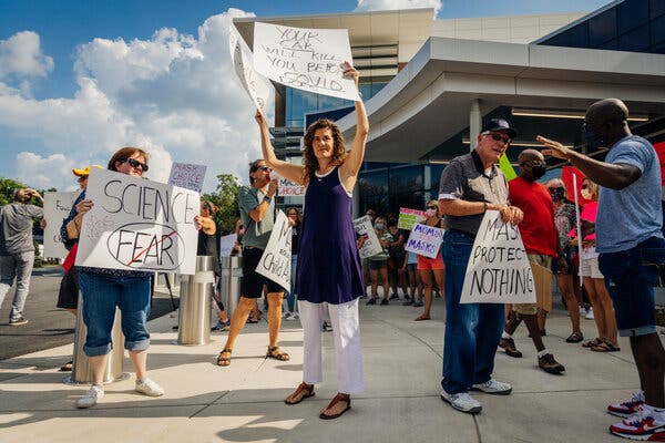 Protesters rallied for and against mask mandates outside the Cobb County School District headquarters in Marietta, Ga., on Thursday.