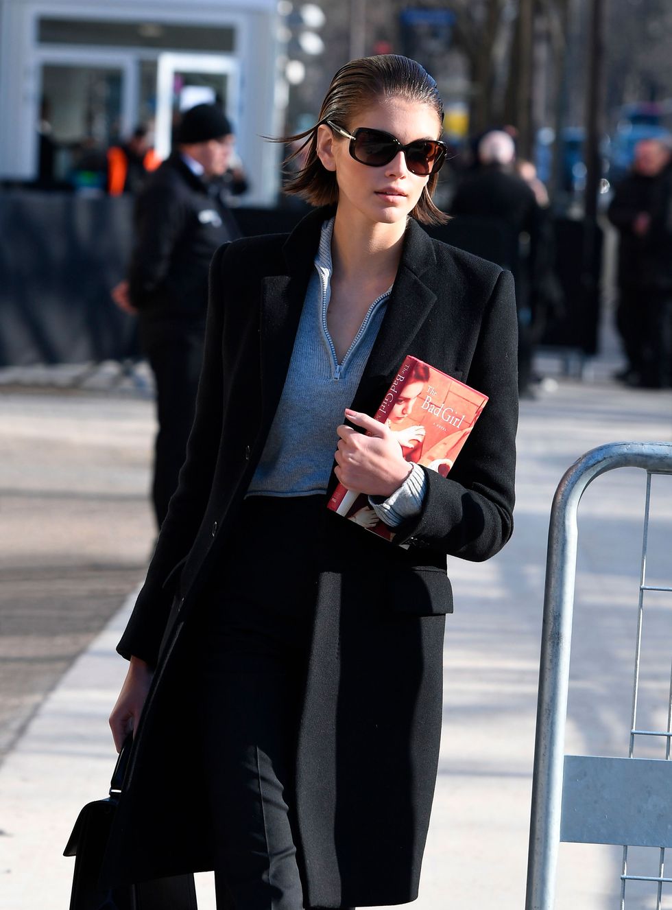 kaia gerber carrying a book at fashion week