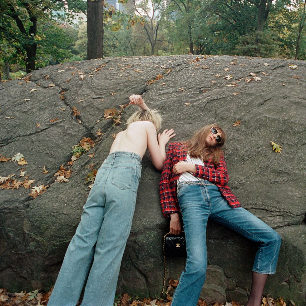 two women lying on a rock
