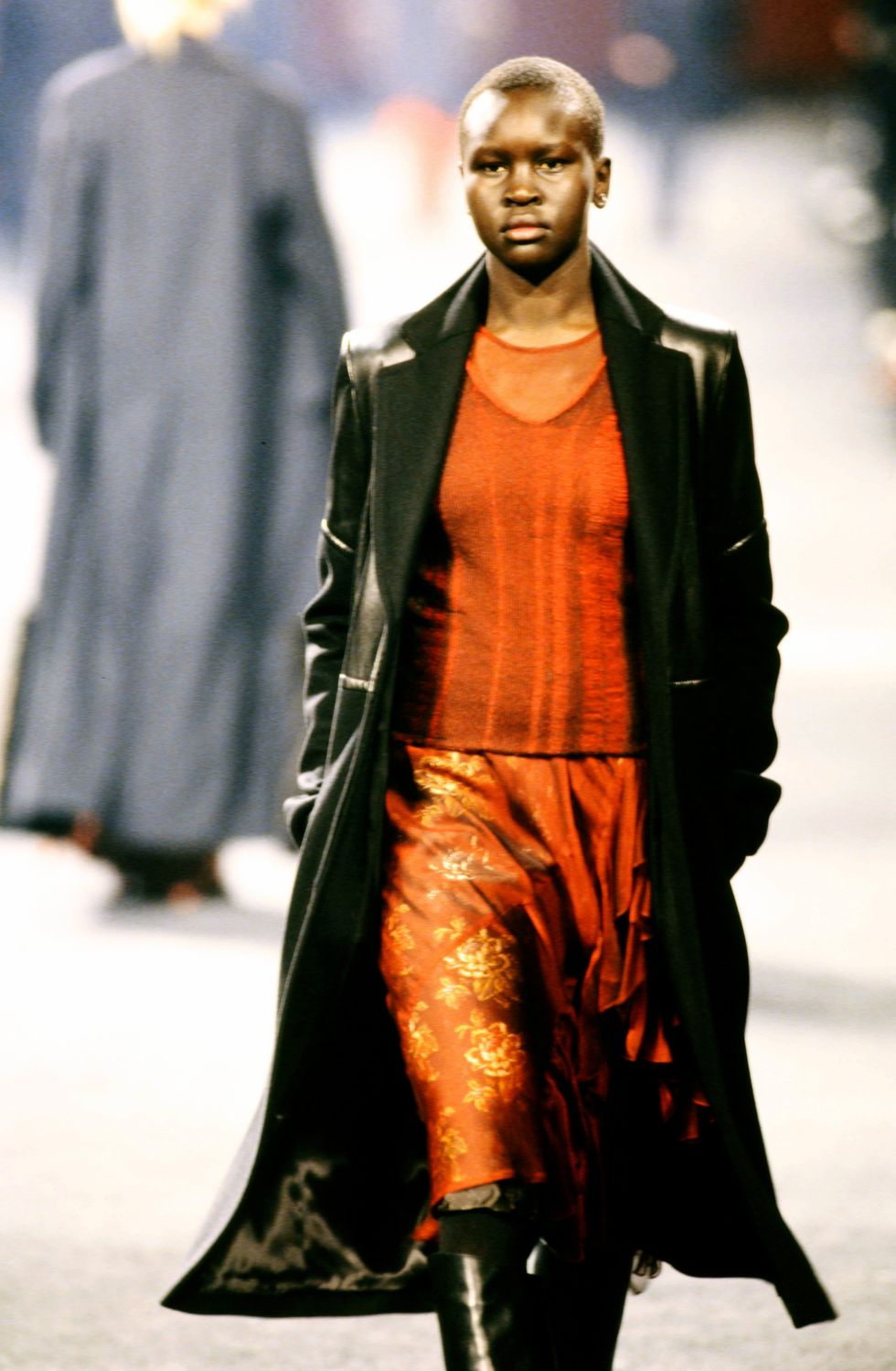 a black woman with short hair walking the runway