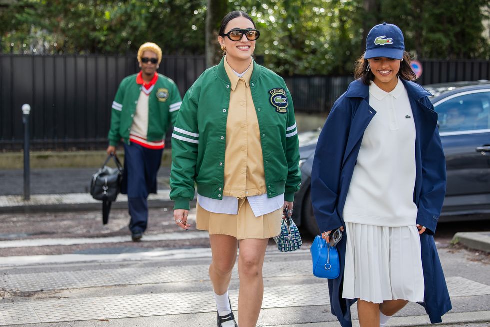two women crossing the street in preppy outfits