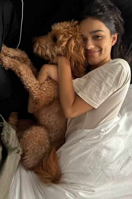 a person lying on a bed with a stuffed animal