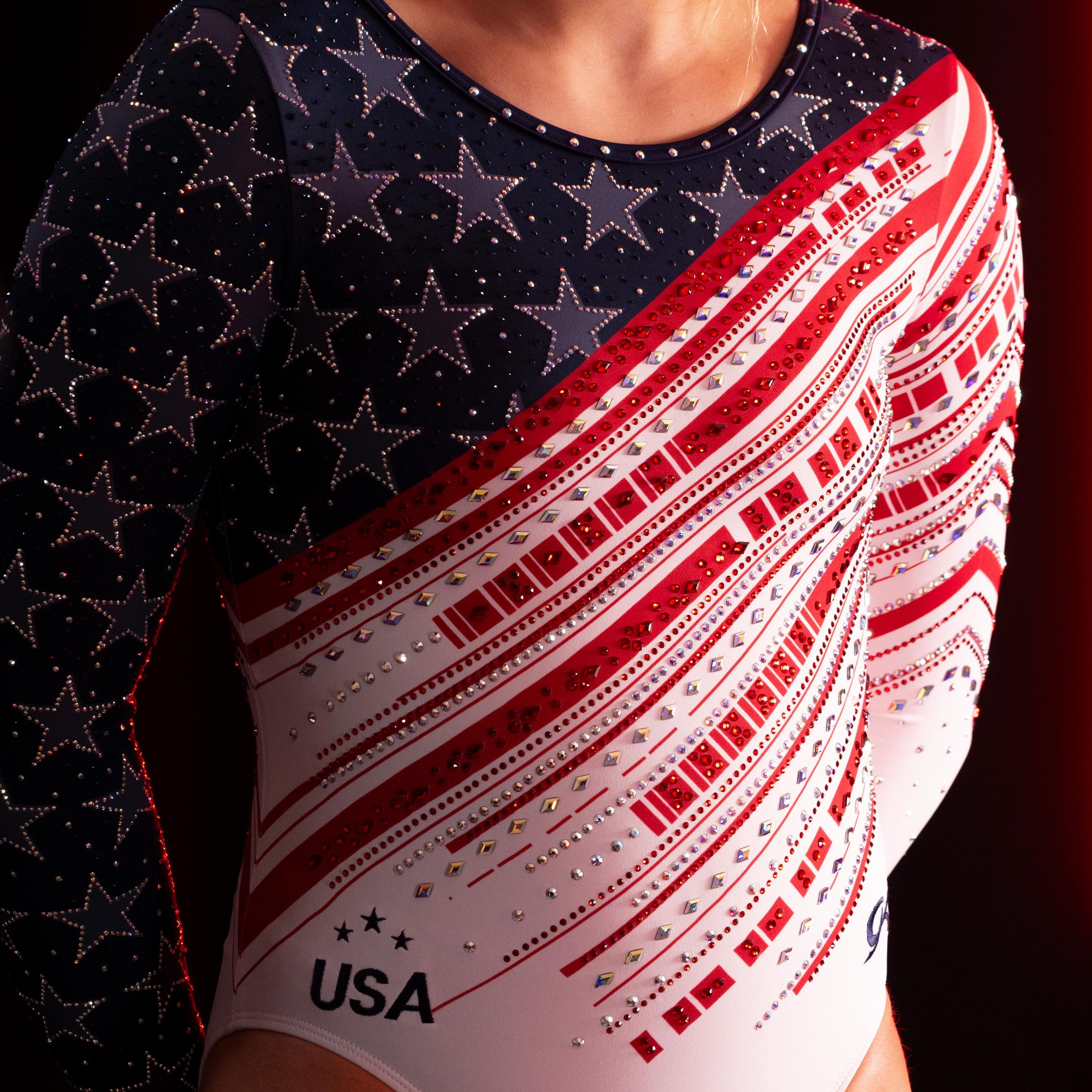 a woman wearing a black and red garment with a white and red logo