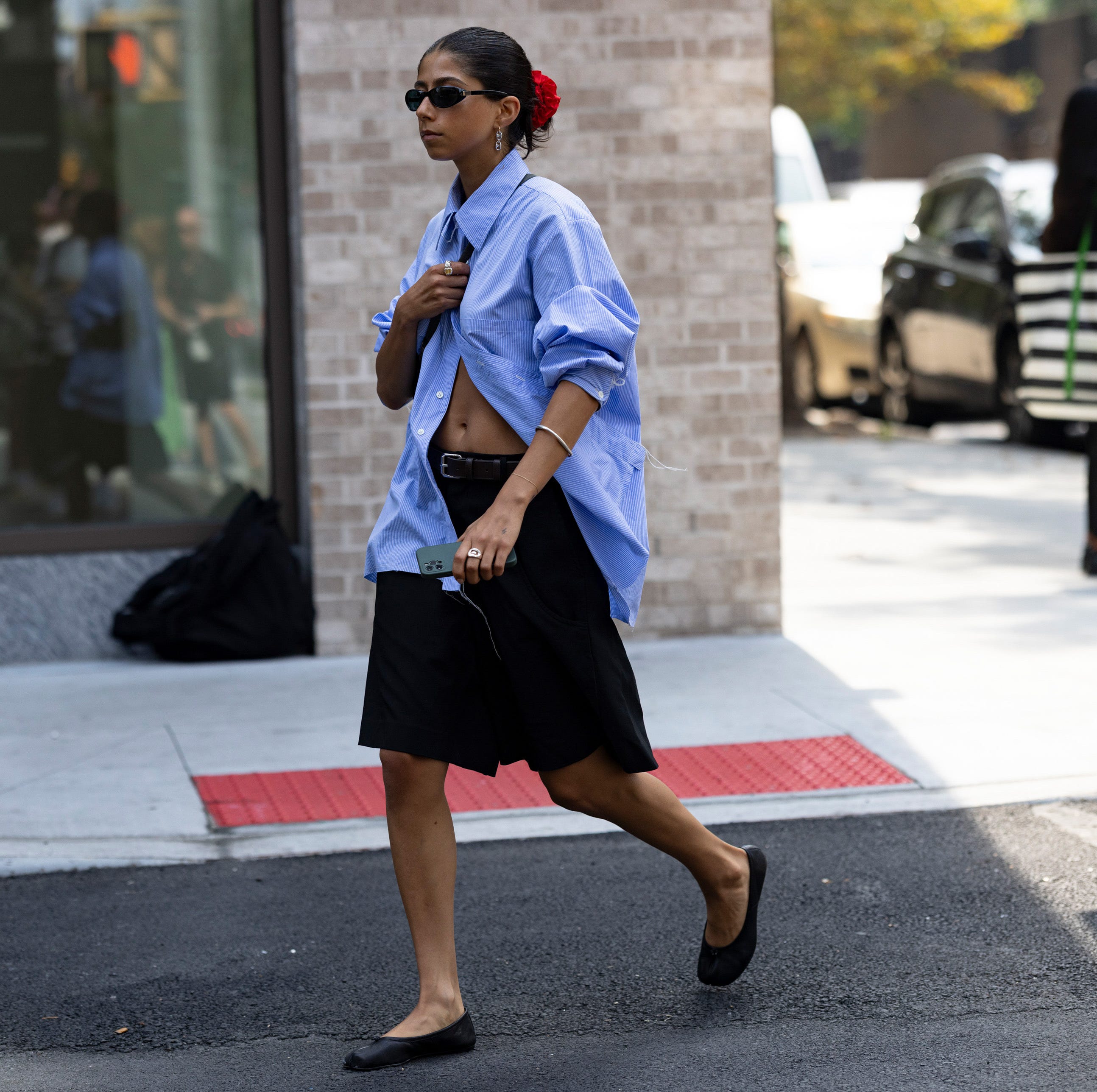 a person in a skirt walking on the street