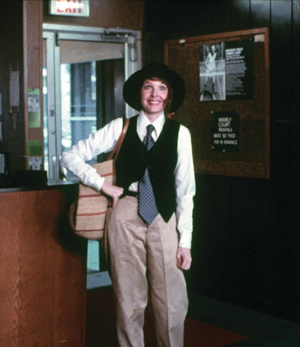 a woman in a suit and hat