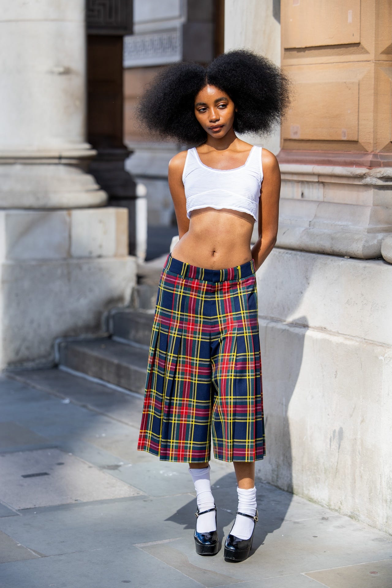 london, england september 14 joyce cisse wears white cropped shirt, checkered navy red blue shorts, white socks, platform heels outside kent curwen during london fashion week september 2024 on september 14, 2024 in london, england photo by christian vieriggetty images