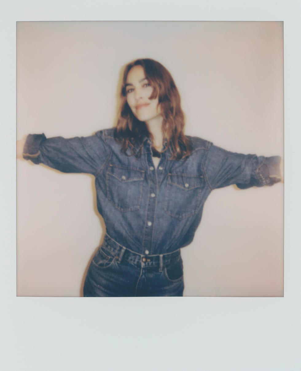 a woman wearing a denim top and jeans