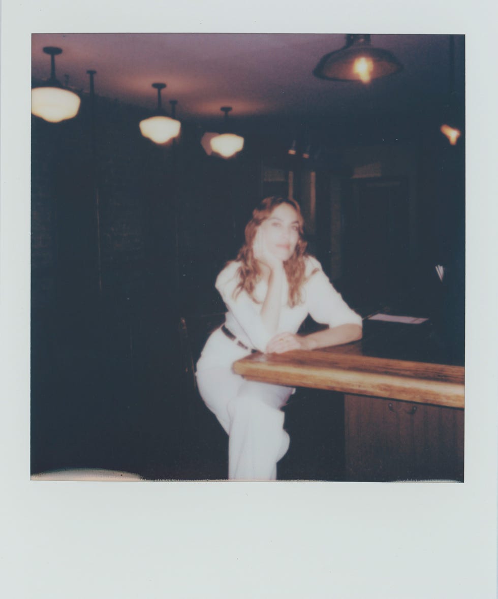 a woman sitting at a bar