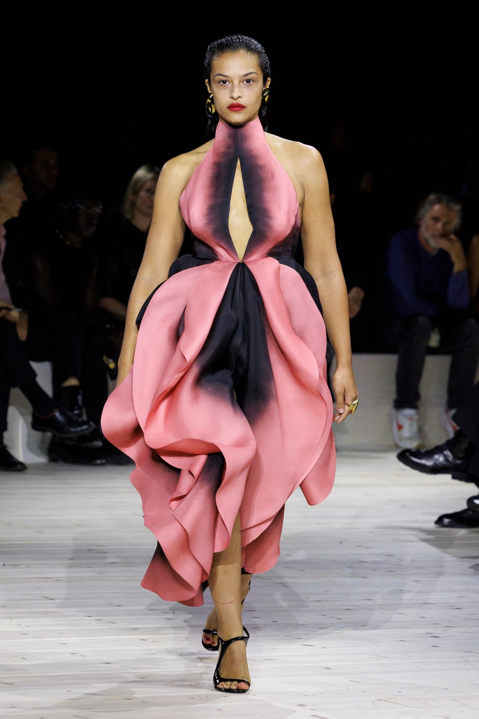 a woman in a pink and black ruffled gown