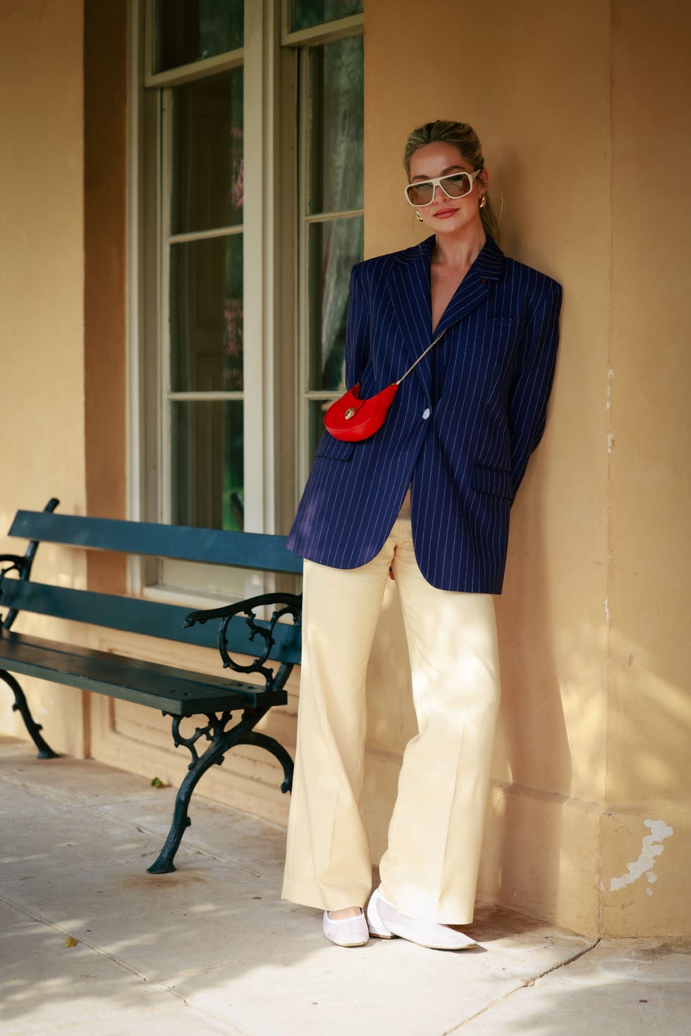 sydney, australia may 16 brooke mcauley wearing navy pin stripped jacket, white oversized sunglasses and beige pants and red bvlgari bag during australian fashion week presented by pandora 2024 at carriageworks on may 16, 2024 in sydney, australia photo by hanna lassengetty images