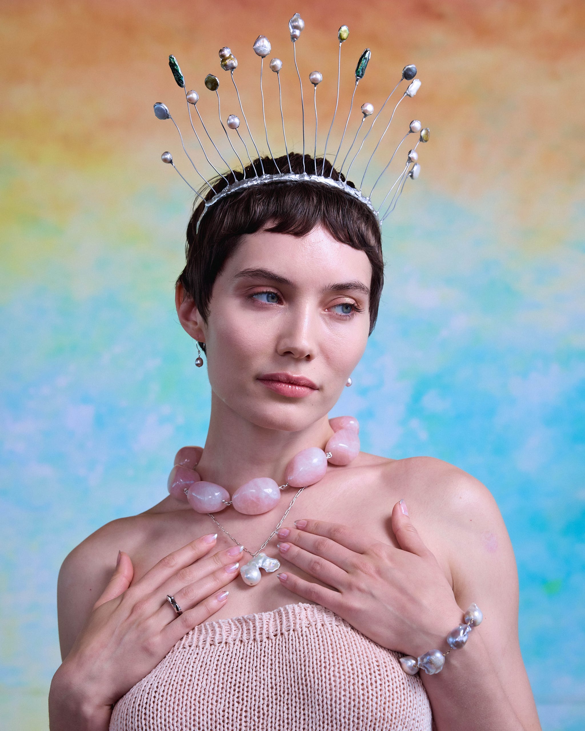 a woman wearing a crown made of thin wires with decorative elements on top