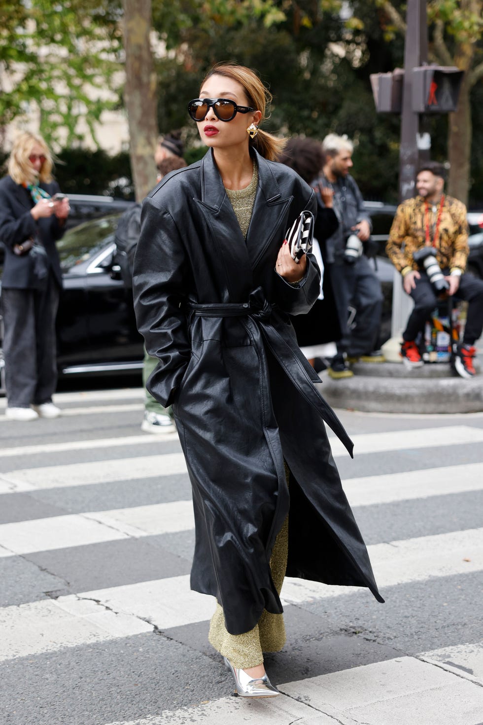 paris, france september 24 rosana chloe lai wears long olive green dress, black long leather coat, black and white zebra print bag, silver heels, outside dior, during womenswear springsummer 2025 as part of paris fashion week on september 24, 2024 in paris, france photo by claudio laveniagetty images