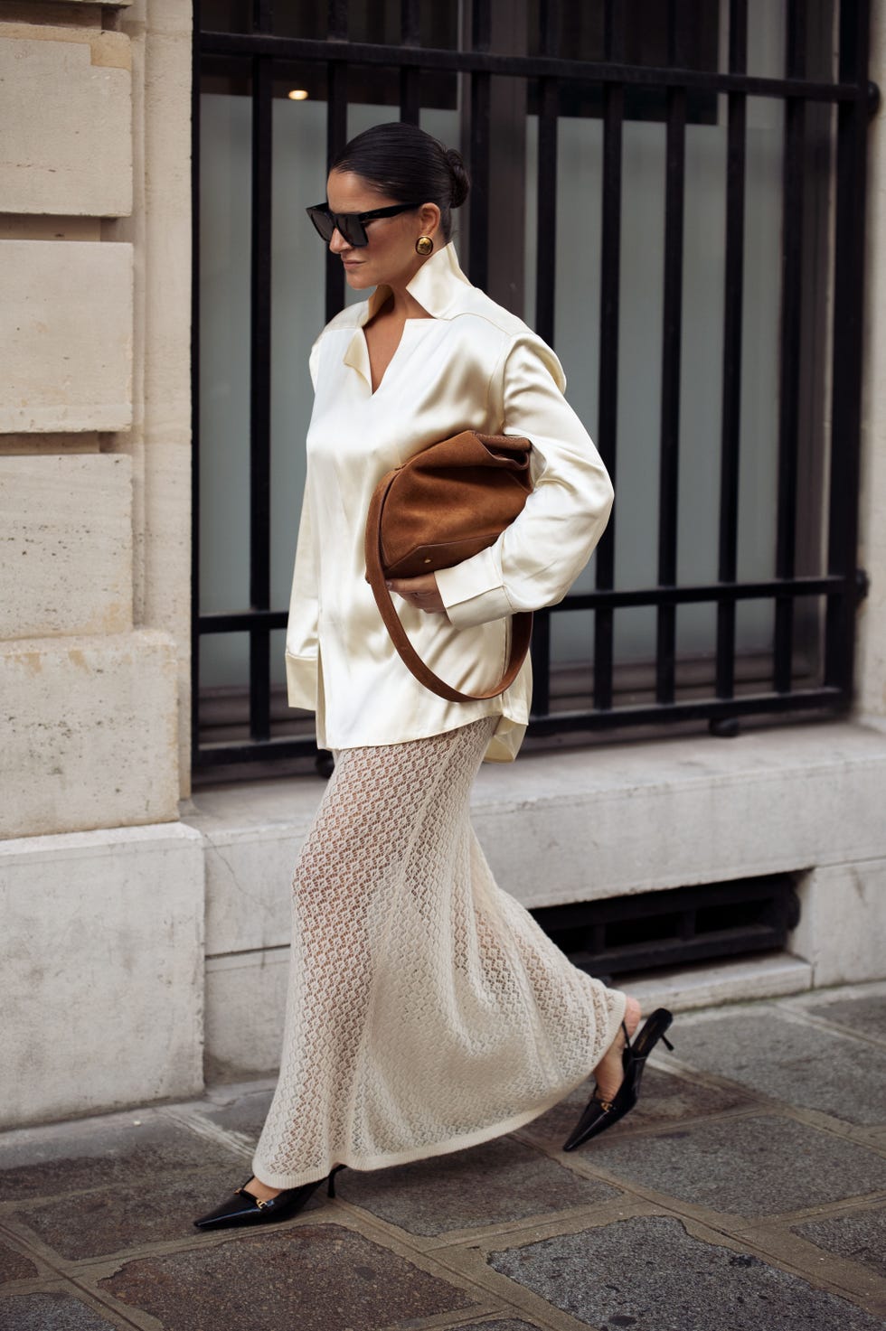 paris, france september 27 gili biegun wears silk shirt with neck details by bevza, knitted maxi skirt by herskind, brown suede bag by elleme and shoes by saint laurent, celine sunglasses during womenswear springsummer 2025 as part of paris fashion week on september 27, 2024 in paris, france photo by raimonda kulikauskienegetty images