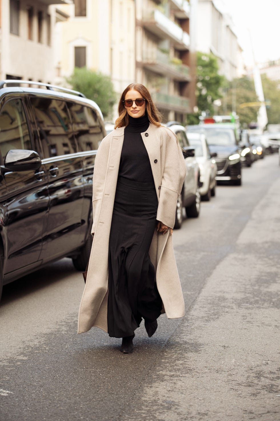 milan, italy september 19 victoria magrath wears a long black dress and trench coat outside max mara show during the milan fashion week menswear springsummer 2025 on september 19, 2024 in milan, italy photo by raimonda kulikauskienegetty images