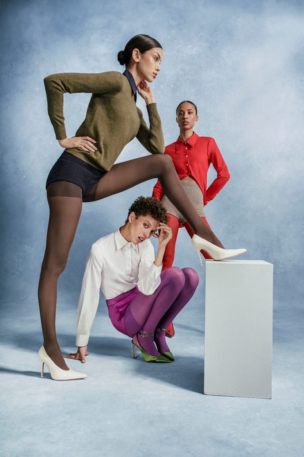 three models showcasing fashion with various outfits and tights