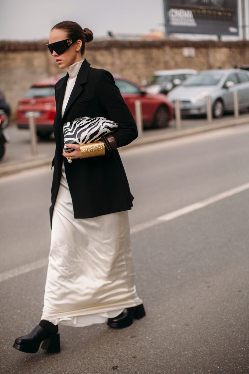 Person walking on a street in a fashionable outfit