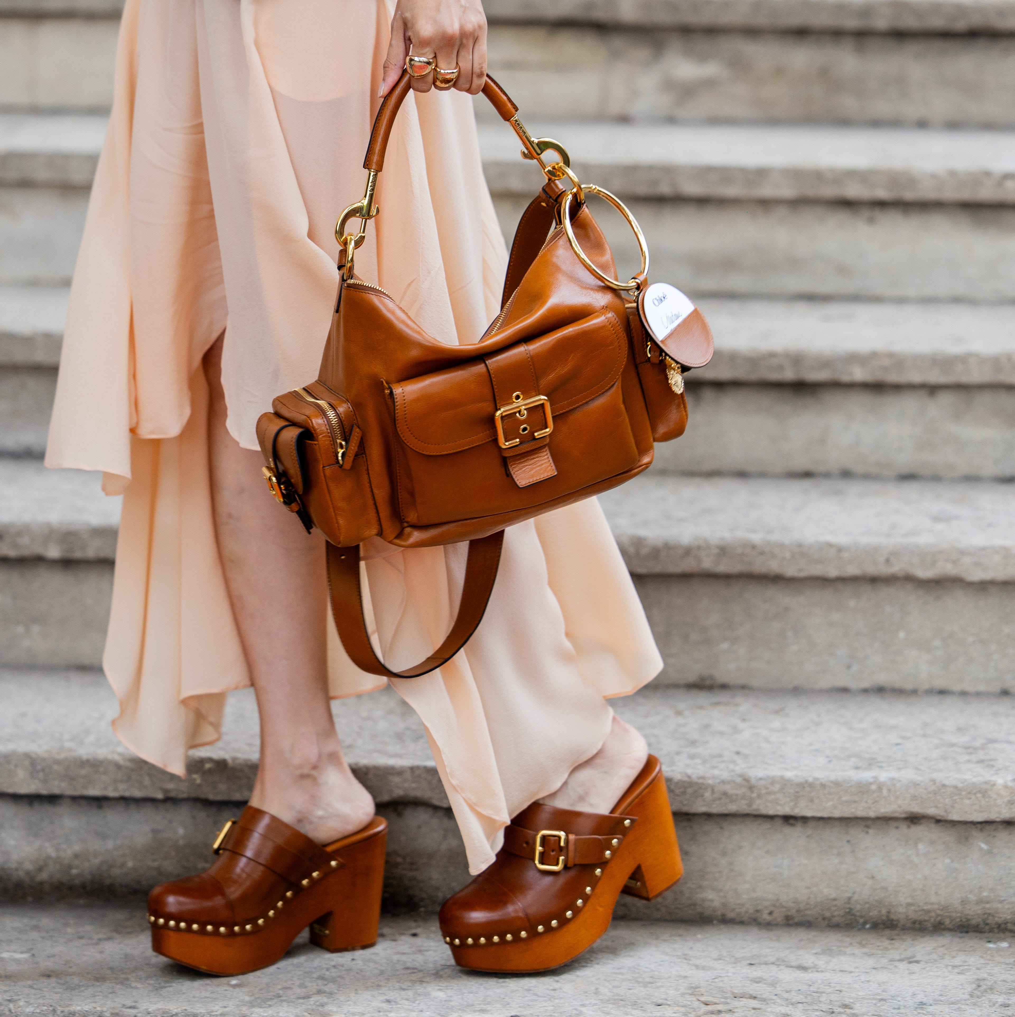 paris, france september 26 elva ni wears brown vest, golden necklace, skirt, brown bag, clogs outside chloe during womenswear springsummer 2025 as part of paris fashion week on september 26, 2024 in paris, france photo by christian vieriggetty images