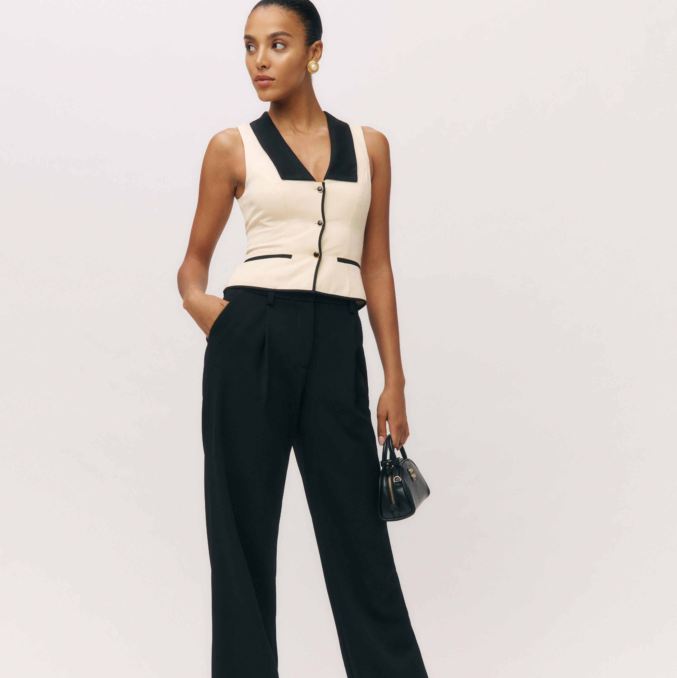 fashionable outfit featuring a sleeveless top and tailored pants