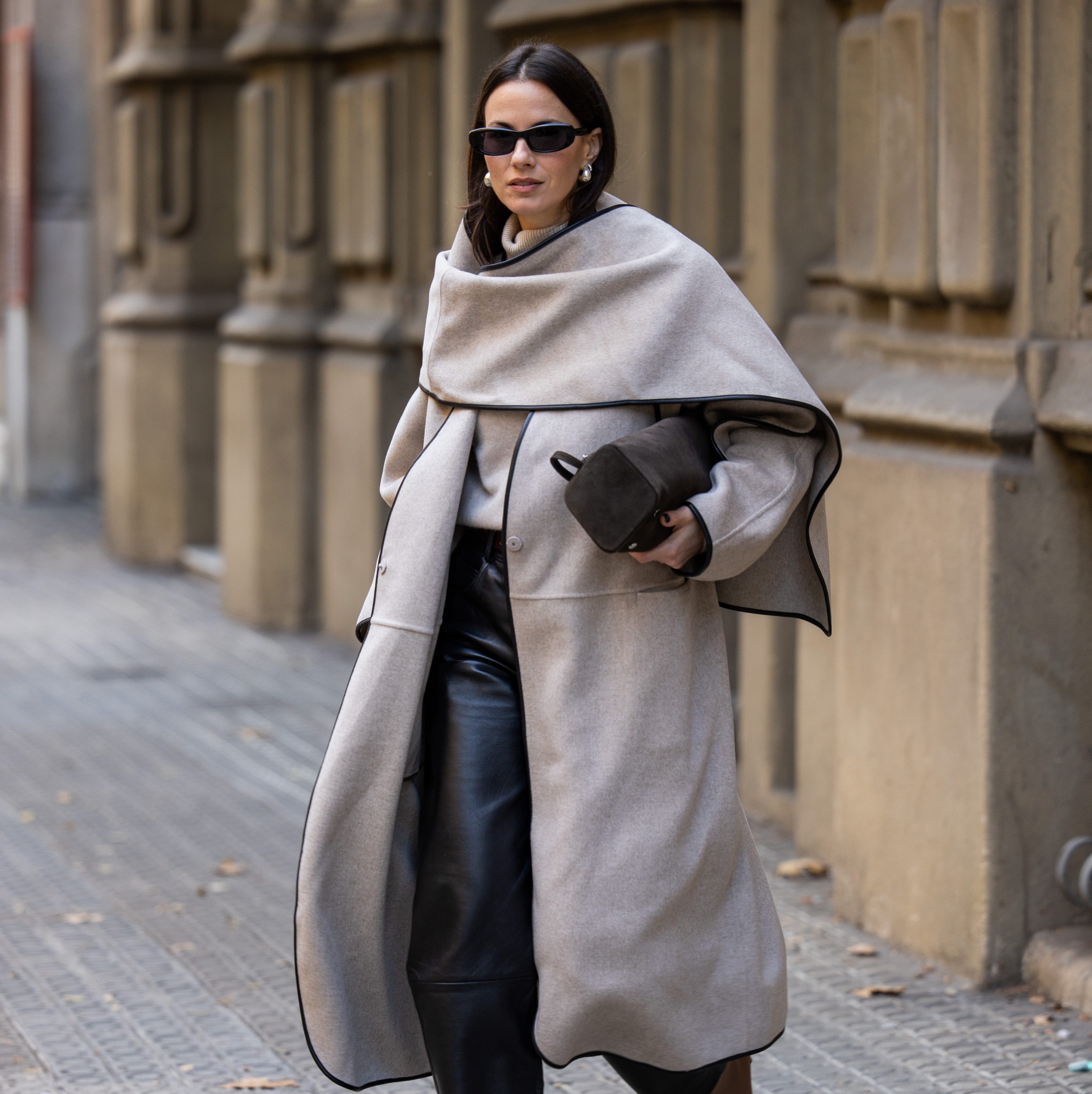 barcelona, spain november 11 zina charkoplia wears brown neous boots, almada sweater, black lamarque leather pants, grey cos coat with cape, podyh bag on november 11, 2024 in barcelona, spain photo by christian vieriggetty images