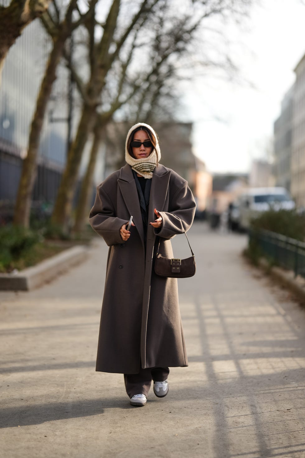 paris, france january 20 a guest wears a white hood balaclava, a brown oversized long trench coat, a brown suede bag, sneakers shoes, outside kolor, during the menswear fallwinter 20242025 as part of paris fashion week on january 20, 2024 in paris, france photo by edward berthelotgetty images